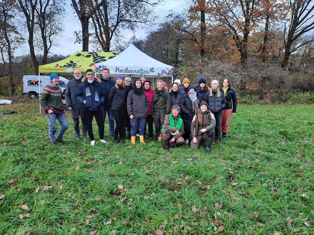 Gruppe Menschen steht draußen vor einem Pavillon